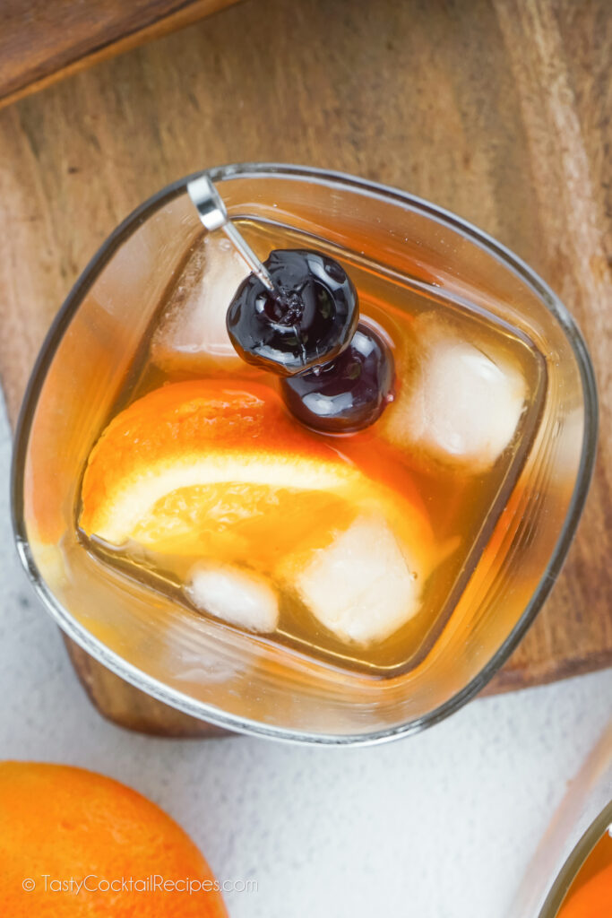 top-down view of an old fashioned cocktail made with bourbon and cherries