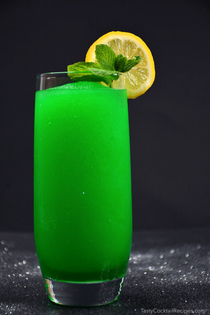 Bright green frozen drink in a tall glass