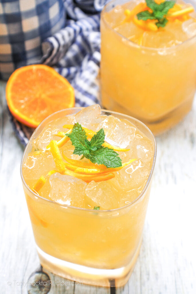 Two Glasses of Orange Whiskey Smash cocktail 