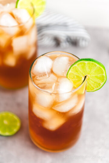 top down view of dark and stormy rum cocktails with lime.