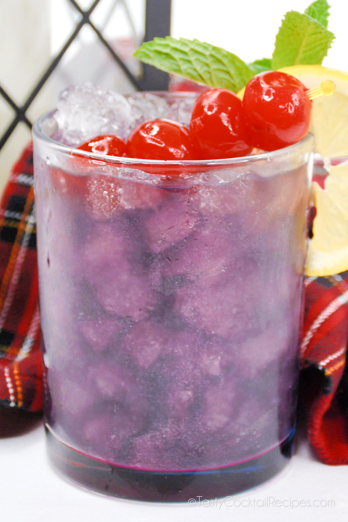bright purple cocktail with cherries.