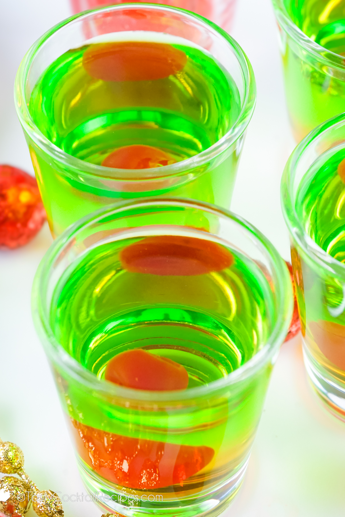 green drinks with red cherry inside.